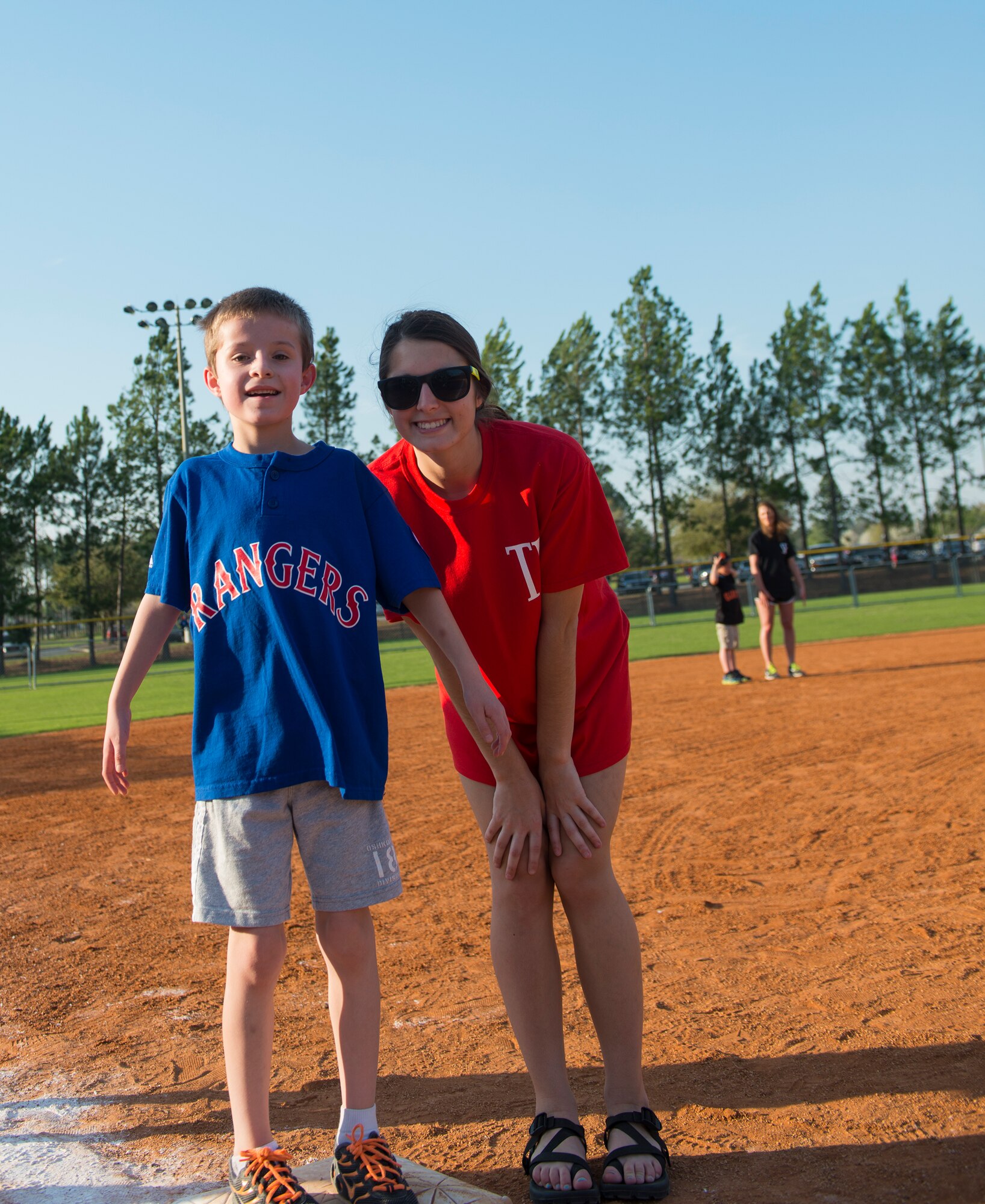 Jackson Jones, son of U.S. Air Force Tech. Sgt. Keith Jones, 723d Aircraft Maintenance Squadron, and Courtney Sutton, Miracle League buddy, pose for a photo during the Miracle League of Valdosta’s baseball game March 17, 2015, in Valdosta, Ga. Each child was assigned a ‘buddy’ to work with and assist them in their growth and development both on and off the field. (U.S. Air Force photo by Airman 1st Class Ceaira Tinsley/Released)