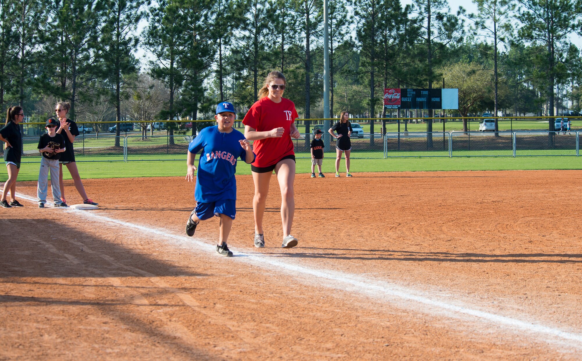 Justin Castillo, son of U.S. Air Force Tech. Sgt. Adrian Castillo, 23d Maintenance Operations Flight, and Alex Alter, Miracle League of Valdosta volunteer, race to home plate during the Miracle League of Valdosta’s baseball game March 17, 2015, in Valdosta, Ga. Team Moody members participated in the league as players, coaches, buddies and volunteers. (U.S. Air Force photo by Airman 1st Class Ceaira Tinsley/Released)