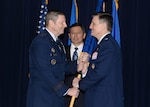Gen. Robin Rand (left), commander of Air Education and Training Command, passes the Profession of Arms Center of Excellence guidon to Col. Jeffrey Smith, signifying his assumption as the PACE director during a ceremony March 11 at Joint Base San Antonio-Randolph. (U.S. Air Force photo by Tech. Sgt. Joshua Strang)