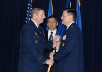 Gen. Robin Rand (left), commander of Air Education and Training Command, passes the Profession of Arms Center of Excellence guidon to Col. Jeffrey Smith, signifying his assumption as the PACE director during a ceremony March 11 at Joint Base San Antonio-Randolph. (U.S. Air Force photo by Tech. Sgt. Joshua Strang)