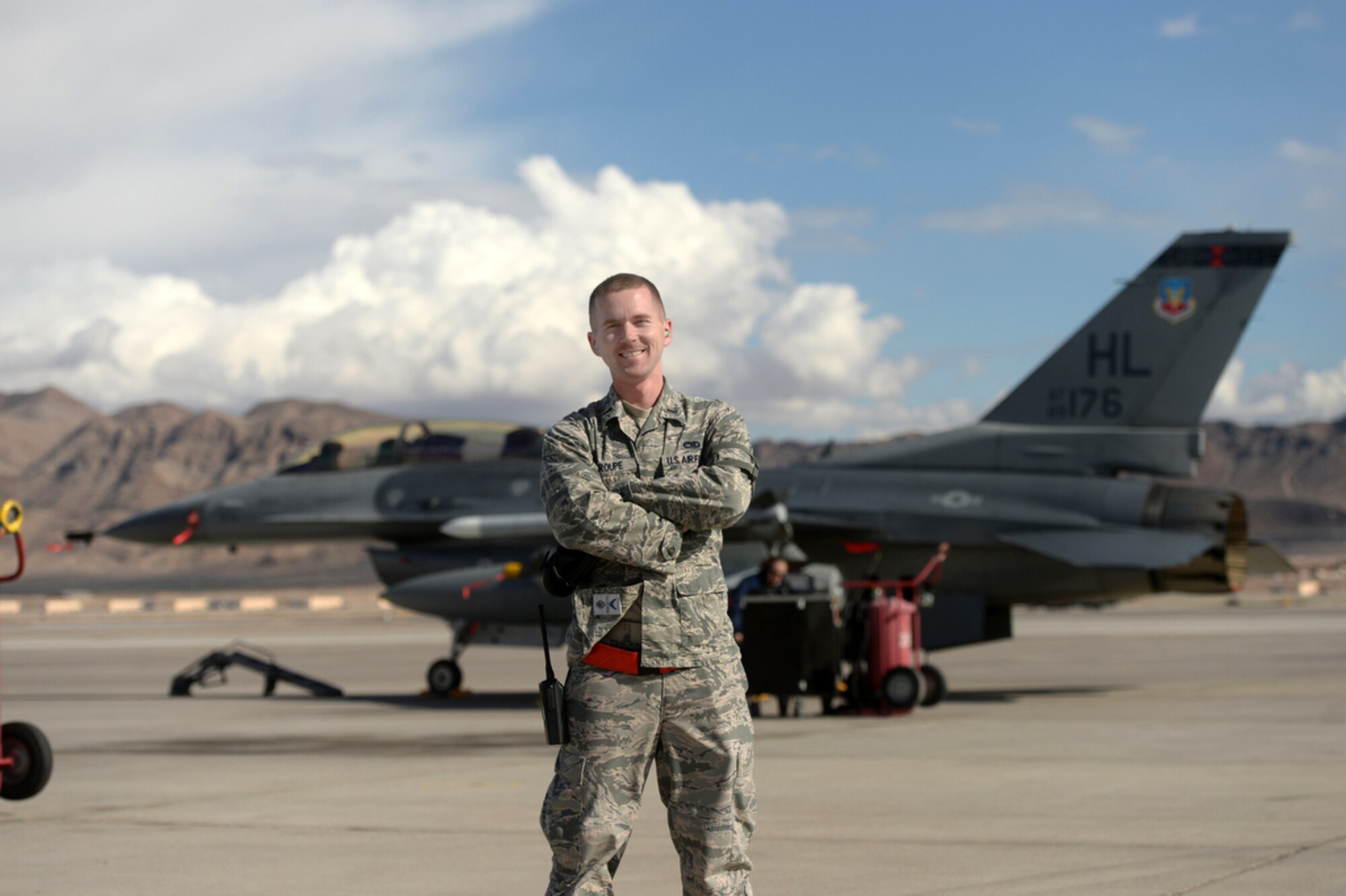 Caption 1st Lt. Nathan Stroupe,  officer in charge of the 421st Fighter Squadron’s Aircraft Maintenance Unit, poses in front of an F-16 Fighting Falcon March 3 during Red Flag 15-2 at Nellis AFB, Nevada. (U.S. Air Force photo by Staff Sgt. Vernon Young)