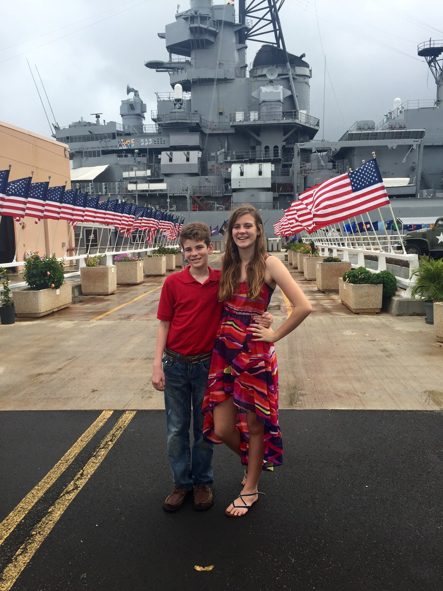 Sydnie and Lance Rouleau, children of U.S. Air Force Lt. Col. Nelson Rouleau, stand in front of the U.S.S. Missouri, Ford Island, Hawaii. Sydnie and Lance created the Rouleau Foundation to offer financial support to members of their military community. (Courtesy photo)