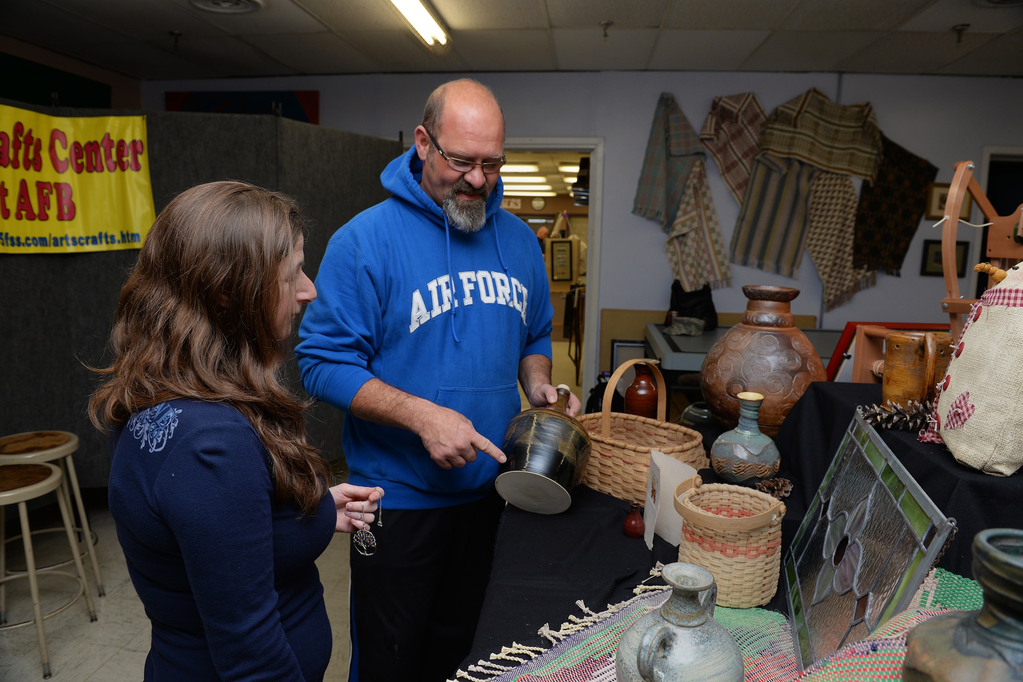 Becky McDaniel and Norman Wiggins, demonstrators at the upcoming Arts and Crafts Center Open House, look at some of the crafts they will help share with the Scott Air Force Base, Illinois community, March 13, 2015. The open house is March 21, 2015 from 9 to 4, and will feature 23 artisans showcasing different crafts and hobbies. (U.S. Air Force photo by Airman 1st Class Erica Crossen)