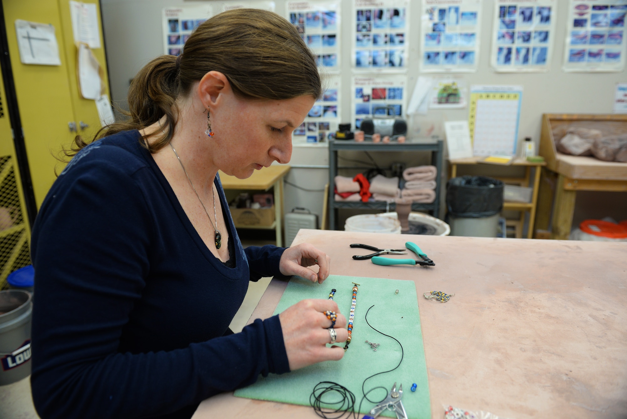 Becky McDaniel, Jewelry Demonstrator at the upcoming Arts and Crafts Center Open House, builds a bracelet similar to what she will show at the open house, Scott Air Force Base, Illinois, March 13, 2015. The open house is March 21, 2015 from 9 to 4, and will feature 23 artisans showcasing different crafts and hobbies. (U.S. Air Force photo by Airman 1st Class Erica Crossen)