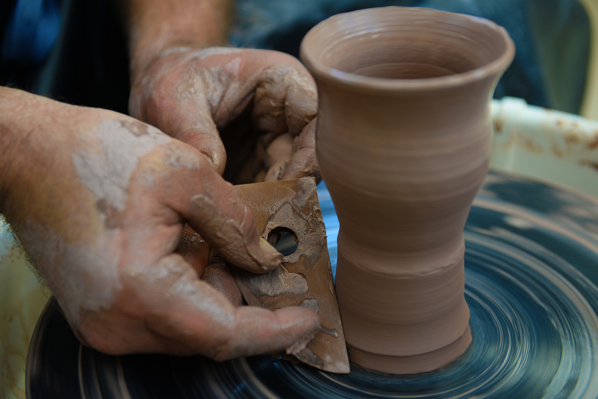 Norman Wiggins, Pottery Instructor at the Scott Air Force Base Arts and Crafts Center, works with clay as he will at the upcoming Arts and Crafts Center Open House, Scott Air Force Base, Illinois, March 13, 2015. Interested individuals are free to try out the pottery wheel themselves at the open house. The open house is March 21, 2015 from 9 to 4, and will feature 23 artisans showcasing different crafts and hobbies. (U.S. Air Force photo by Airman 1st Class Erica Crossen)