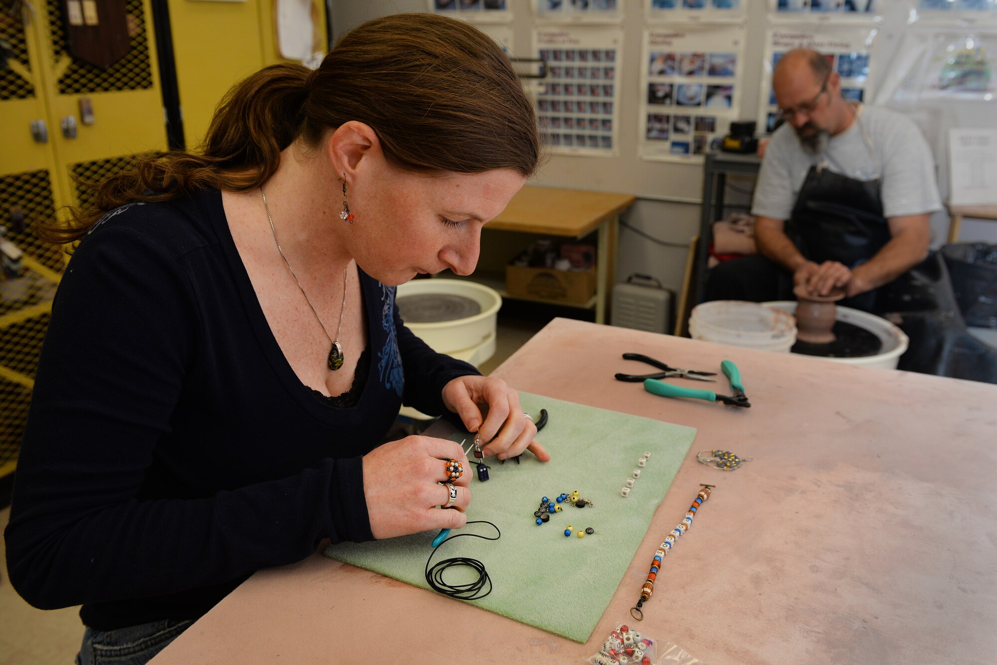Becky McDaniel and Norman Wiggins, demonstrators at the upcoming Arts and Crafts Center Open House, work with the crafts they will share with the Scott Air Force Base, Illinois community, March 13, 2015. The open house is March 21, 2015 from 9 to 4, and will feature 23 artisans showcasing different crafts and hobbies. (U.S. Air Force photo by Airman 1st Class Erica Crossen)