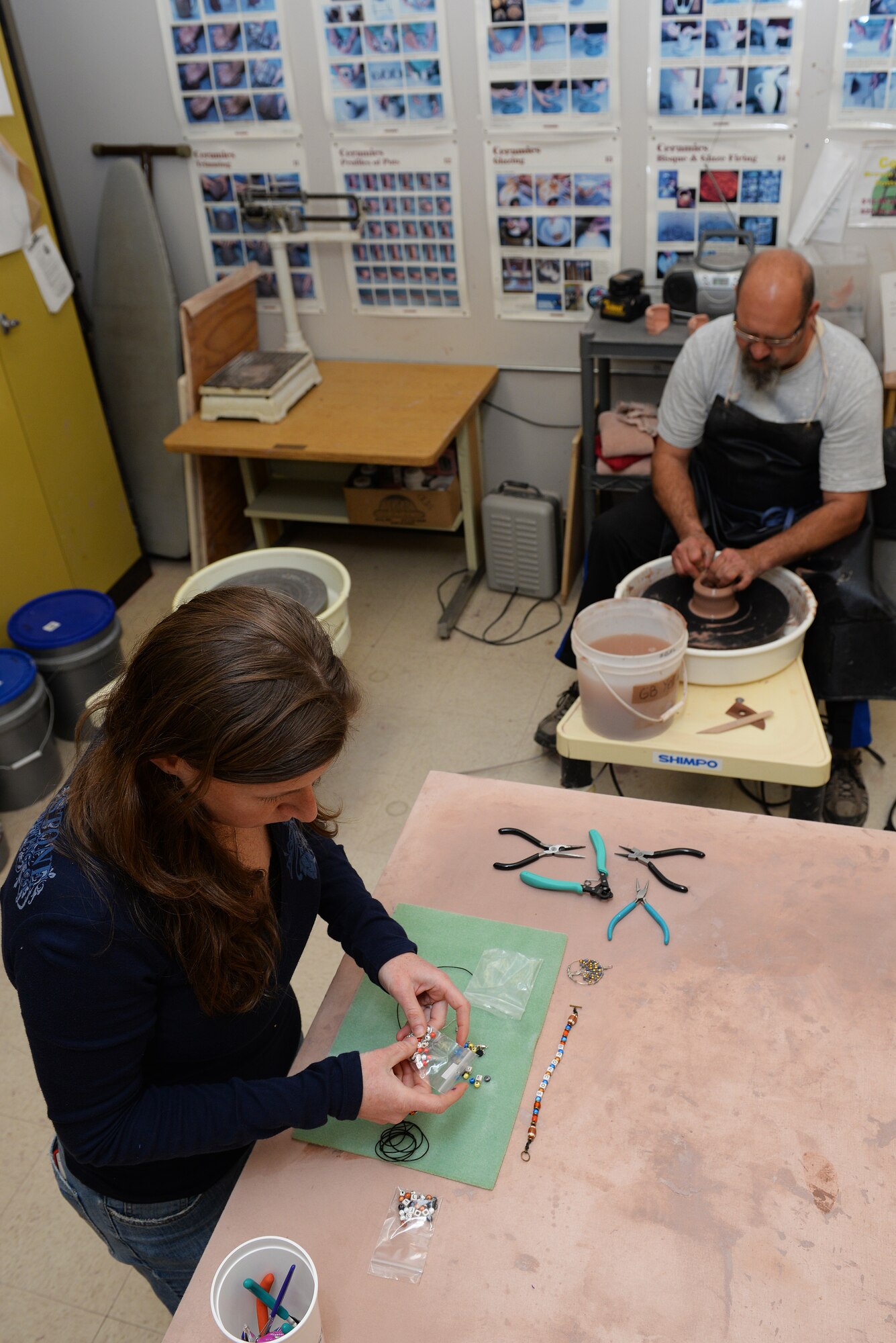 Becky McDaniel and Norman Wiggins, demonstrators at the upcoming Arts and Crafts Center Open House, work with the crafts they will share with the Scott Air Force Base, Illinois community, March 13, 2015. The open house is March 21, 2015 from 9 to 4, and will feature 23 artisans showcasing different crafts and hobbies. (U.S. Air Force photo by Airman 1st Class Erica Crossen)