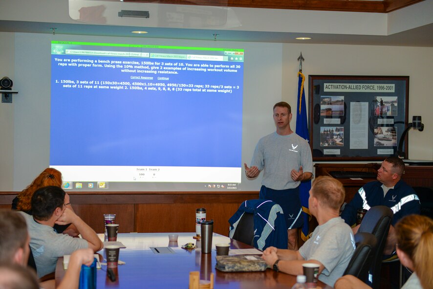 Members of the 93d Air Ground Operations Wing participate in a fitness questionnaire competition during their Comprehensive Airmen Fitness Day March 13, 2015, at Moody Air Force Base, Ga. U.S. Air Force Lt. Col. Jon Wilson, 93d AGOW director of human performance, hosted the game after his physical fitness briefing to review what the Airmen learned. (U.S. Air Force photo by Airman Greg Nash/Released)