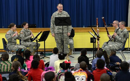 The U.S. Army Training and Doctrine Command Band Woodwind Quintet perform a sing-along song for kindergarten and first-grade students at George J. McIntosh Elementary School in Newport News, Va., March 16, 2015. During the month of March, TRADOC Band performance teams travel to schools in the local area ranging from elementary schools to high schools and some colleges to teach students about music and the Army . (U.S. Air Force photo by Staff Sgt. Teresa J. Cleveland/Released)