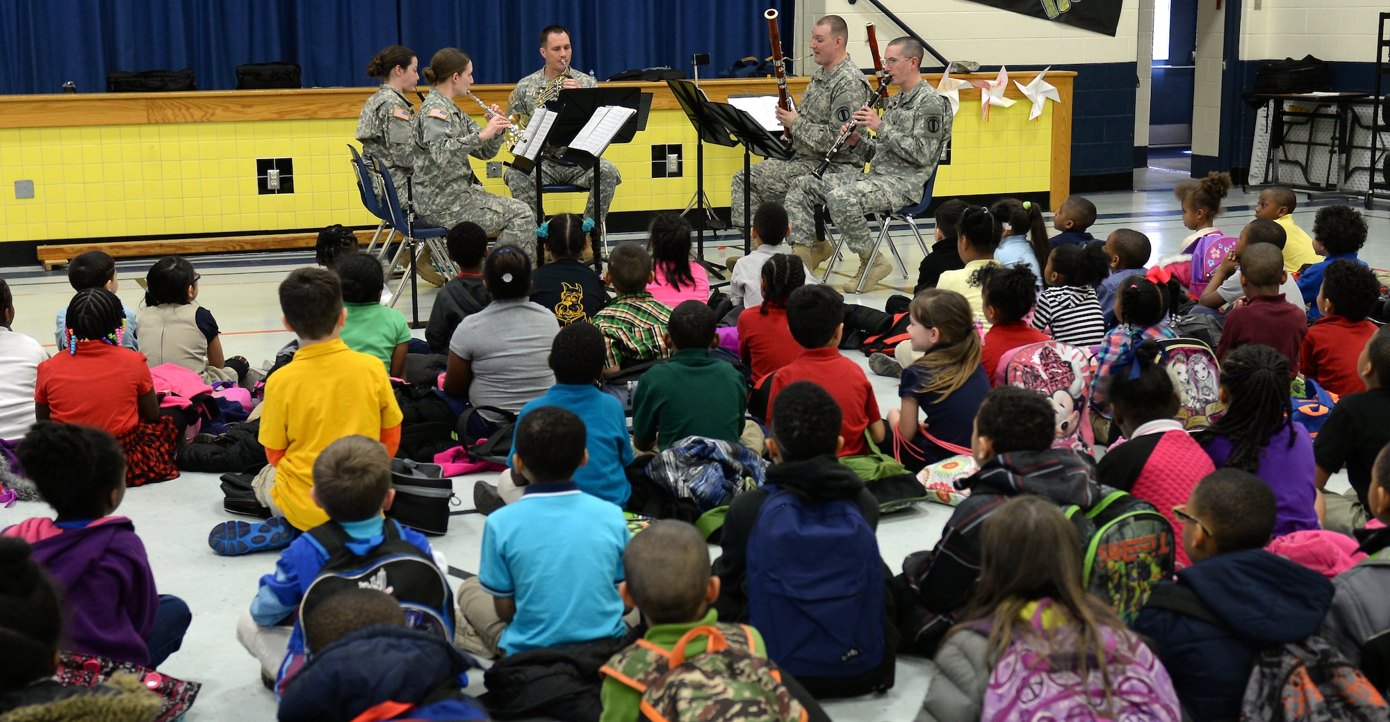 The U.S. Army Training and Doctrine Command Band Woodwind Quintet perform for kindergarten and first-grade students at George J. McIntosh Elementary School in Newport News, Va., March 16, 2015. Performance teams from the TRADOC band travel to Hampton Roads area schools to perform and teach children about the Army and music. (U.S. Air Force photo by Staff Sgt. Teresa J. Cleveland/Released)