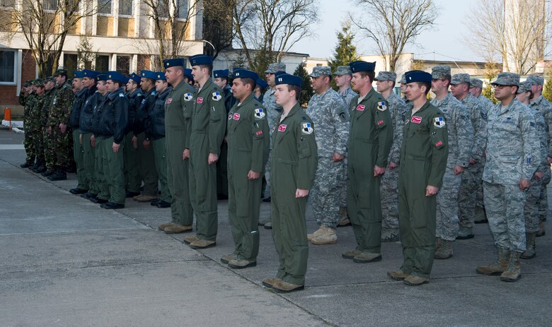 U.S. and Romanian Airmen stand at attention for a flag ceremony at Campia Turzii, Romania, March 16, 2015. The Romanian air force hosted an opening ceremony to kick off exercise Dacian Warhawk. (U.S. Air Force photo/ Staff Sgt. Armando A. Schwier-Morales)