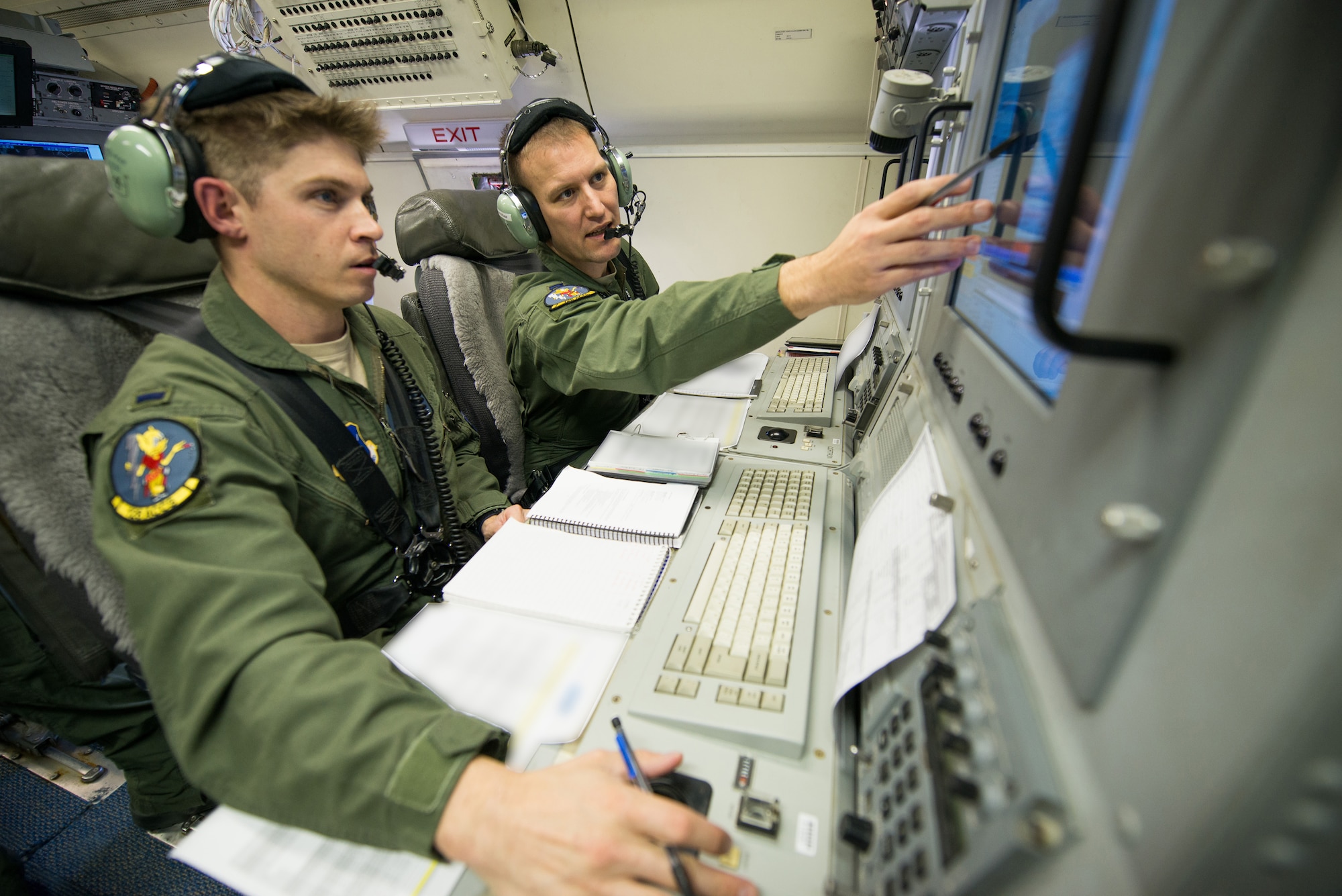 U.S. Air Force aircrew members with the 116th Air Control Wing, Georgia Air National Guard, monitor surveillance information during a mission aboard an E-8C Joint STARS (JSTARS), Robins Air Force Base, Ga., Nov. 15, 2014. The JSTARS platform provides wide-area, all-weather, surface surveillance radar that is used in a combat capacity supporting combatant commanders across the globe. They can also provide valuable data during domestic natural disasters; such as hurricanes and tornadoes, by communicating real-time geographic data to ground personnel to help safely evacuate citizens. (U.S. Air National Guard photo by Tech. Sgt. Regina Young/Released)(Portions of the photo have been blurred and names withheld for security purposes)