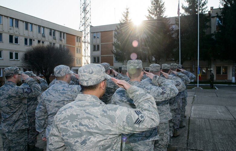 Airmen from U.S. Air Forces in Europe salute as both U.S. and Romanian flags are raised March 16, 2015 at Campia Turzii, Romania. The morning ceremony officially opened Dacian Warhawk, a joint exercise designed to increase the interoperability of both nations. (U.S. Air Force photo/Staff Sgt. Armando A. Schwier-Morales)