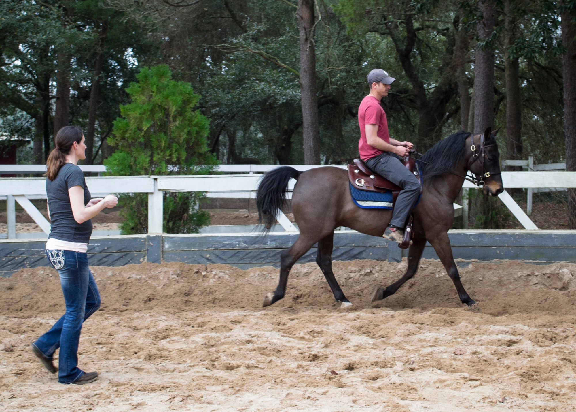 A member of the Eglin Air Force Base Sand and Spur Riding Club, left, teaches a  Soldier assigned to the 7th Special Forces Group (Airborne) how to safely ride a horse March 5. Members of the riding club helped Green Berets from the unit learn how to properly care for, pack and ride horses, improving their means of infiltration and increasing their mobility while deployed to austere locations.  (U.S. Army photo/ Capt.Thomas Cieslak) 