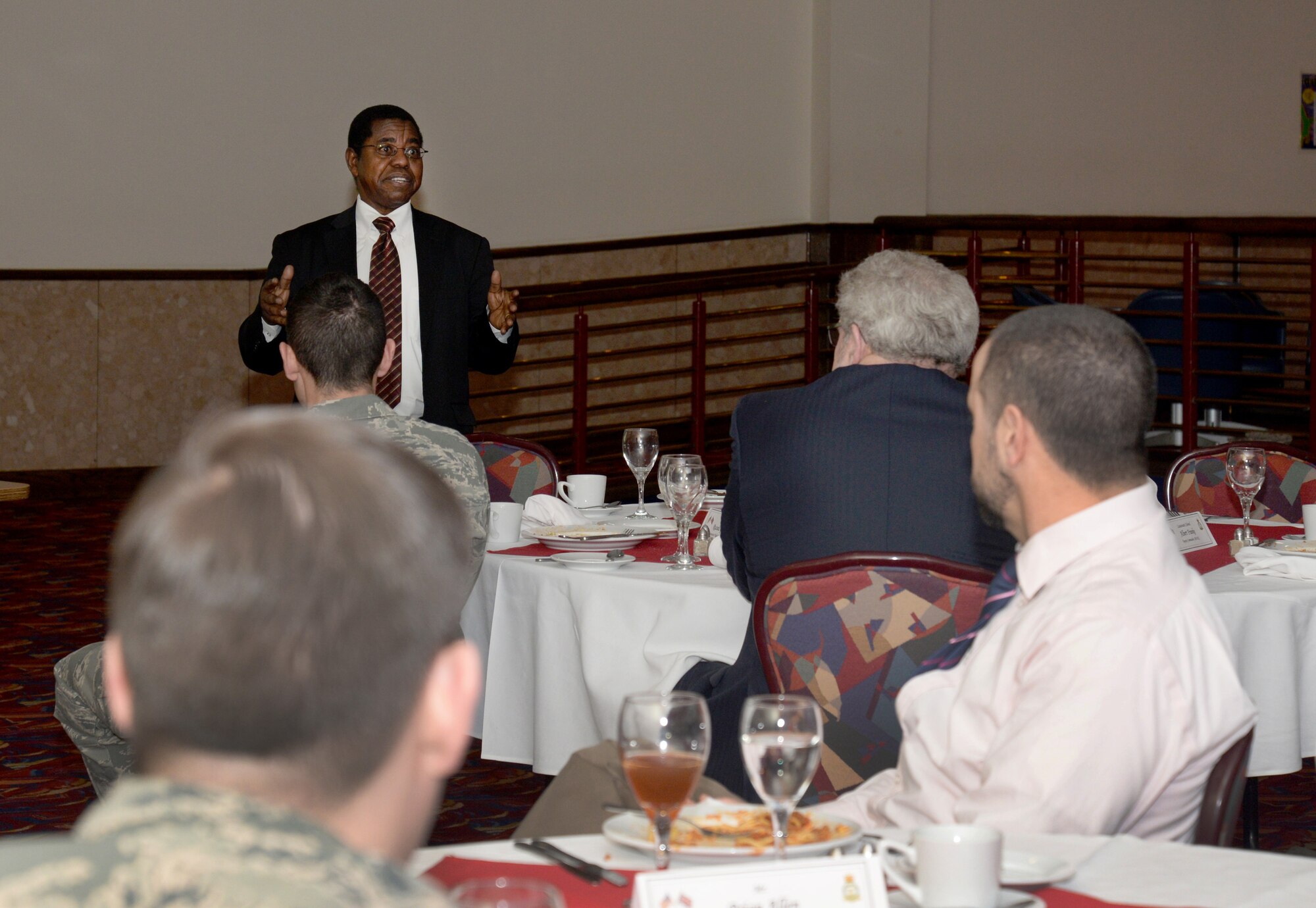 Dr. Adedji B. Badiru, back, Air Force Institute of technology Dean of the Graduate School of Engineering and Management, speaks to U.S. Air Force members and civilians about AFIT March 11, 2015, during his visit to RAF Mildenhall, England. The dean’s visit gave him insight into how the base operates and constantly strives for innovation and mission success. (U.S. Air Force photo by Senior Airman Kate Maurer/Released)
