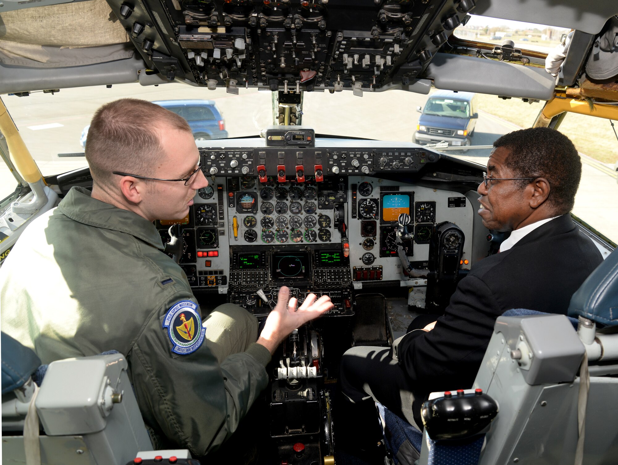 U.S. Air Force 1st Lt. Jason Holien, left, 351st Air Refueling Squadron KC-135 Stratotanker pilot from Deadwood, S.D., explains his role as a pilot and its impact on the mission to Dr. Adedji B. Badiru, Air Force Institute of technology Dean of the Graduate School of Engineering and Management, March 11, 2015, during his visit to RAF Mildenhall, England. The dean’s visit gave him insight into how the base operates and constantly strives for innovation and mission success. (U.S. Air Force photo by Senior Airman Kate Maurer/Released)