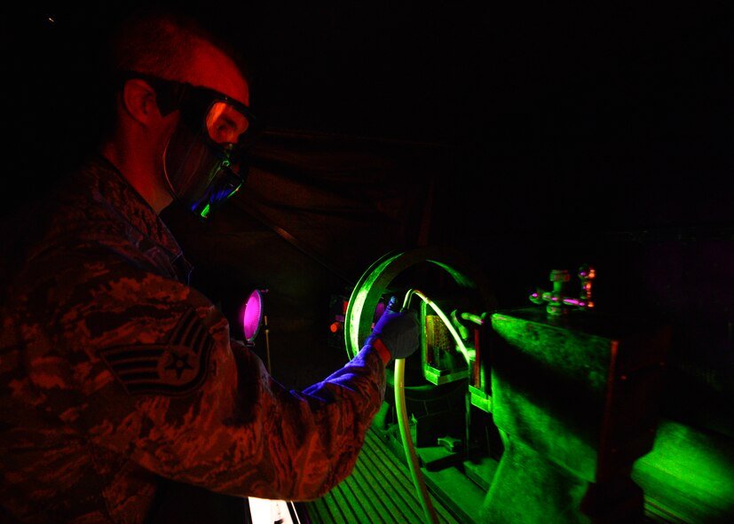 Staff Sgt. Chad Ericksen, 436th Maintenance Squadron Non-destructive Inspection craftsman, conducts particle testing on a crane hook March 13, 2015, at Dover Air Force Base, Del. Ericksen reports the findings of his test into the Parts, Inspection, Turnover (PIT) log that he created in 2012 as a way to better record maintenance records within NDI. (U.S. Air Force photo/Airman 1st Class William Johnson)
