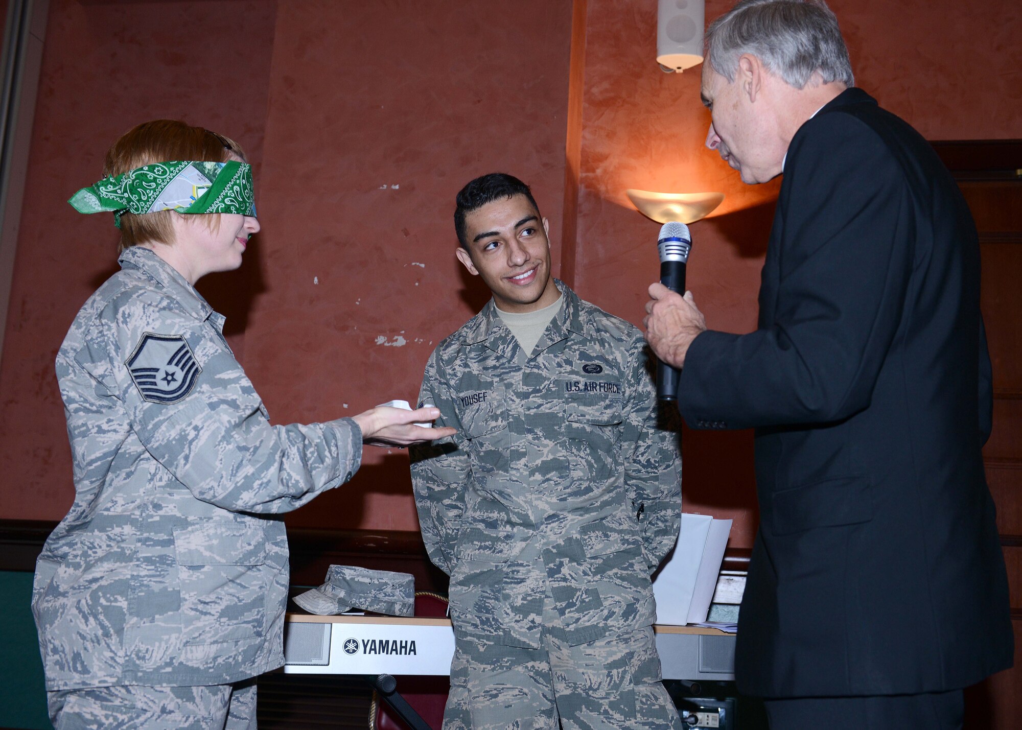Bishop F. Richard Spencer, Auxiliary Bishop Archdiocese for the Military Services, USA, demonstrates the reliability to our senses with U.S. Air Force Master Sgt. Melinda Morris, 31st Fighter Wing equal opportunity office superintendent, and Airman 1st Class Ramzey Yousef, 31st Communications Squadron commander support staff technician, at the 63rd Annual National Prayer Breakfast, March 18, 2015, at Aviano Air Base, Italy. National prayer breakfasts and luncheons are usually held annually at various locations, including overseas military installations. (U.S. Air Force photo by Airman 1st Class Deana Heitzman/Released)