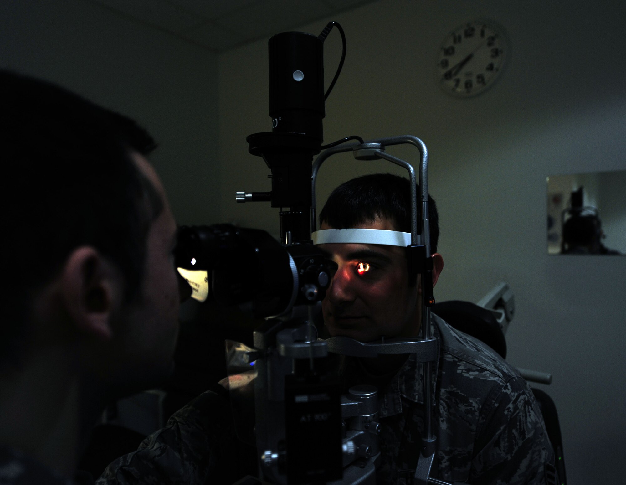 Capt. Anthony Spina, 42nd Medical Group optometrist, performs an eye exam on Senior Airman William Blankenship, 42nd Air Base Wing Public Affairs photojournalist, March 9, 2015, at the 42nd Medical Group Ambulatory Health Care Center, Maxwell Air Force Base, Alabama. The optometry clinic sees between 75 to 100 active-duty and retired Airmen and their dependents each week.  (U.S. Air Force photo illustration by Airman 1st Class Alexa Culbert/Cleared)