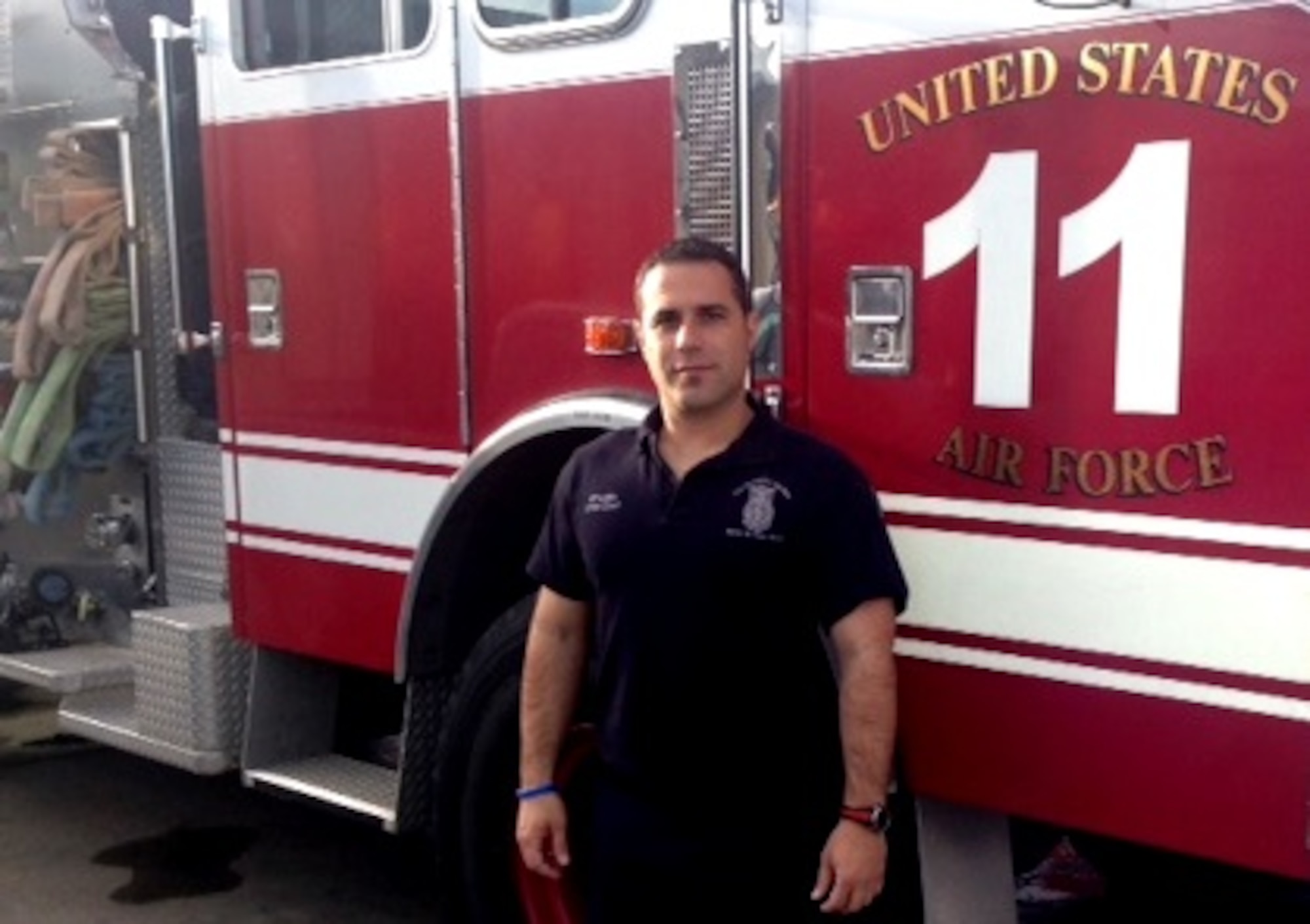 Crew Chief Francisco Castillo Oliva, a firefighter at Morón Air Base, poses for a photo in front of a fire truck at the Spanish base. Oliva saved the life of his neighbor's two-month-old baby while off duty March 4. (Courtesy photo)
