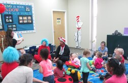 Joint Base Charleston families along with the Cat and in Hat, and Thing 1 and Thing 2 sit and listen to a story written by Dr. Seuss during story time March 5, 2015 at the Weapons Station Library on JB Charleston, S.C. The JB Charleston Libraries celebrated the birthday of famed children's author Dr. Seuss games, crafts and even birthday cupcakes. (Courtesy Photo)