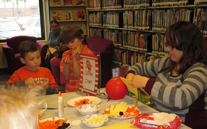 Joint Base Charleston families celebrated the birthday of famed children's author Dr. Seuss March 1, 2015 at the Joint Base Charleston Air Base Library, S.C.. The birthday event included story time, games, crafts and even birthday cupcakes.  The Cat in the Hat along with Thing 1 and Thing 2 made an appearance at the library. (Courtesy Photo) 