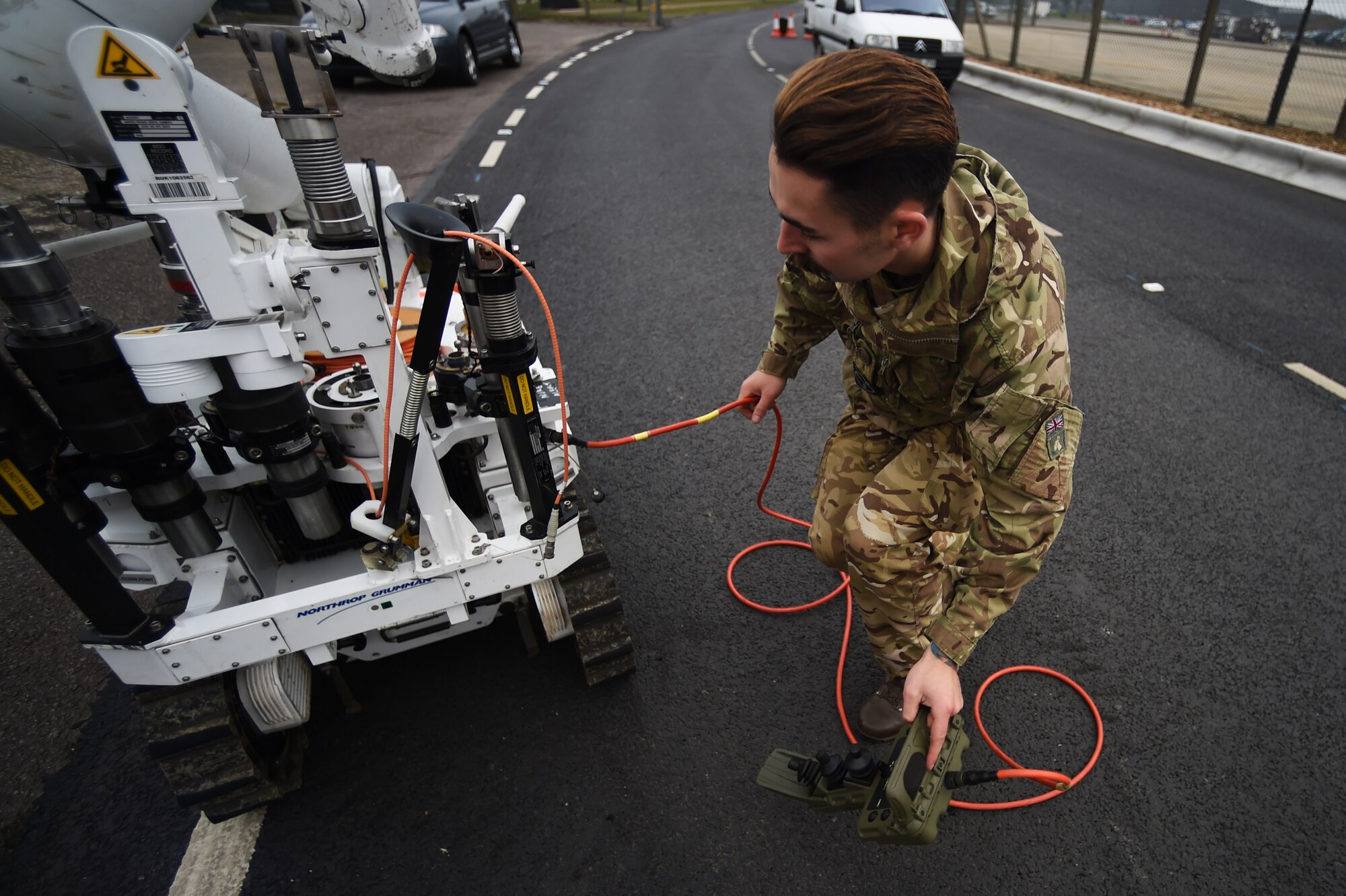 Royal Air Force Senior Aircraftsman Technician Zac Herdman, with the 5131 Bomb Disposal Squadron at RAF Wittering, prepares a bomb disposal robot to be loaded into a mobile command center, following a training exercise at RAF Alconbury, England, March 17, 2015. During the exercise, Herdman guided the robot to respond to and engage with a simulated hazardous incident. (U.S. Air Force photo by Staff Sgt. Jarad A. Denton/Released) 
