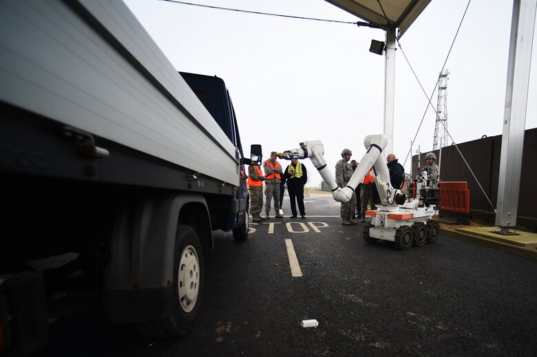 A Royal Air Force 5131 Bomb Disposal Squadron robot approaches a suspicious vehicle, parked at the RAF Alconbury, England, large vehicle inspection gate, during a training exercise, March 17, 2015. During the exercise, UK and U.S. Service members were able to work together to assess and successfully manage a simulated-hazardous situation. (U.S. Air Force photo by Staff Sgt. Jarad A. Denton/Released)