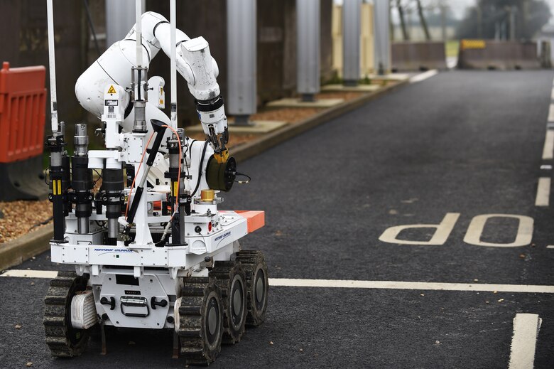 A Royal Air Force 5131 Bomb Disposal Squadron robot moves toward a suspicious vehicle parked at the large vehicle inspection gate during a training exercise at RAF Alconbury, England, March 17, 2015. The robot, dispatched from RAF Wittering, is able to remotely respond to numerous hazardous situations, where it would be too dangerous to send an individual. (U.S. Air Force photo by Staff Sgt. Jarad A. Denton/Released)