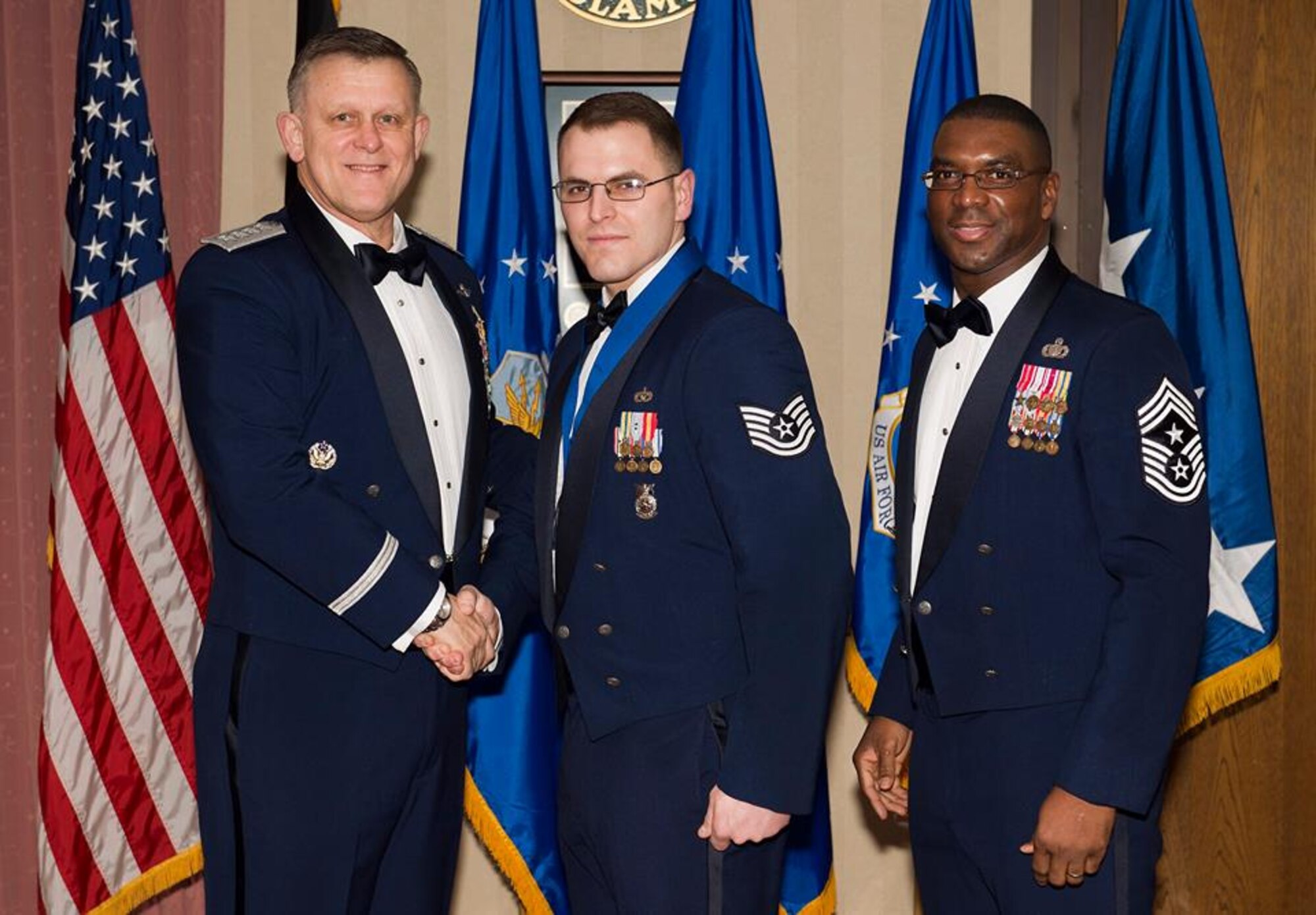 U.S. Air Force Tech. Sgt. David Ordway, center, 100th Civil Engineer Squadron fire protection station chief from Cabot, Ark., receives his U.S. Air Forces in Europe and Air Forces Africa NCO of the Year award from U.S. Air Force Gen. Frank Gorenc, left, USAFE-AFAFRICA commander and U.S. Air Force Chief Master Sgt. James E. Davis, USAFE-AFAFRICA command chief, during an annual medallion ceremony at Ramstein Air Base, Germany, March 5, 2015. Airmen competed within their units, then at wing level and have now been named the best in USAFE-AFAFRICA. They will go on to compete at Air Force-level for the coveted 12 Outstanding Airmen of the Year award which will be announced later this year. (U.S. Air Force photo by Senior Airman Damon Kasberg/Released)