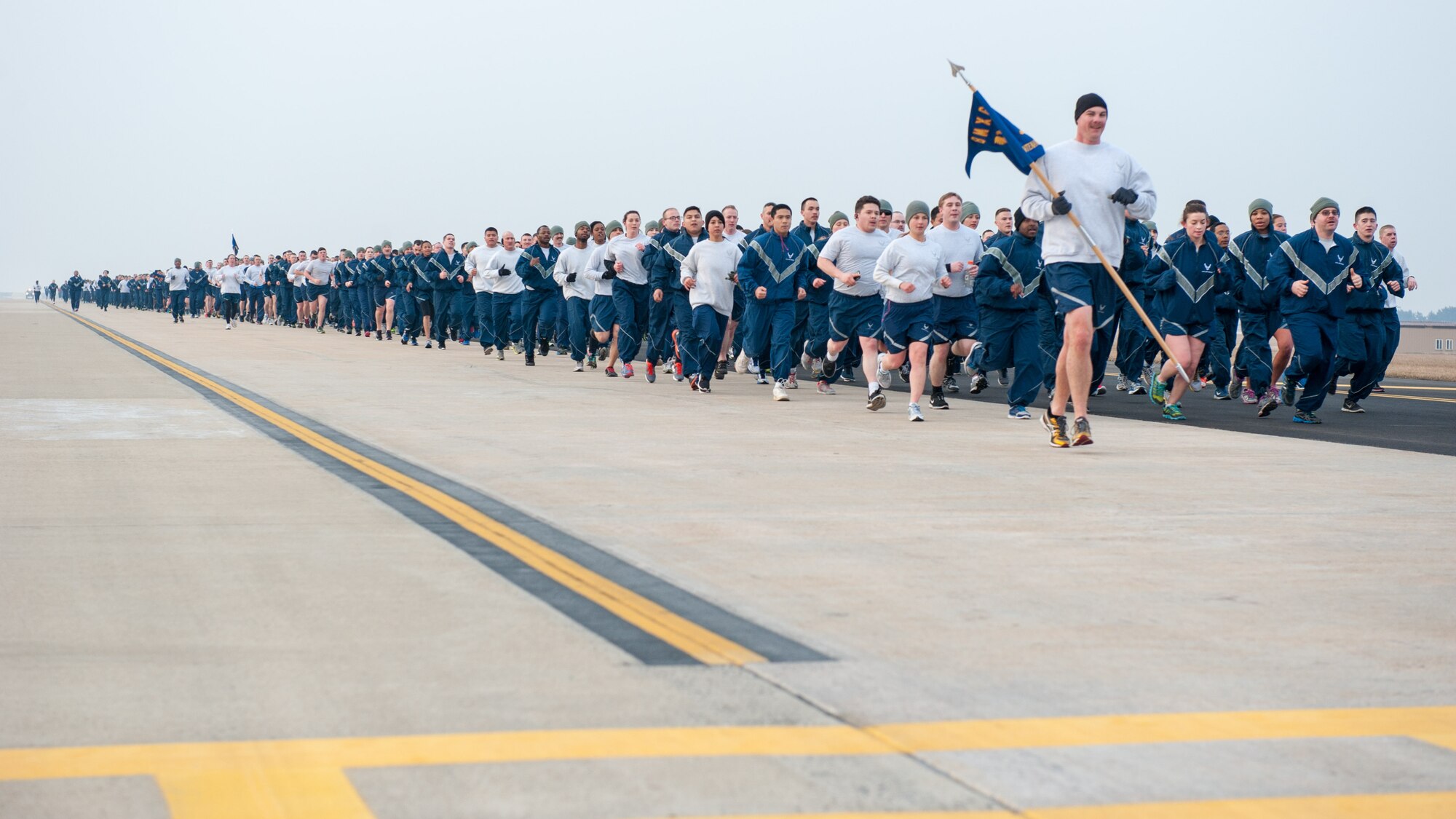 Airmen finish a two mile run during a Wolf Pack Day wing run at Kunsan Air Base, Republic of Korea, March 16, 2015. The run was the first event of the day, which was spent promoting resiliency within the Wolf Pack. (U.S. Air Force photo by Senior Airman Taylor Curry/Released)