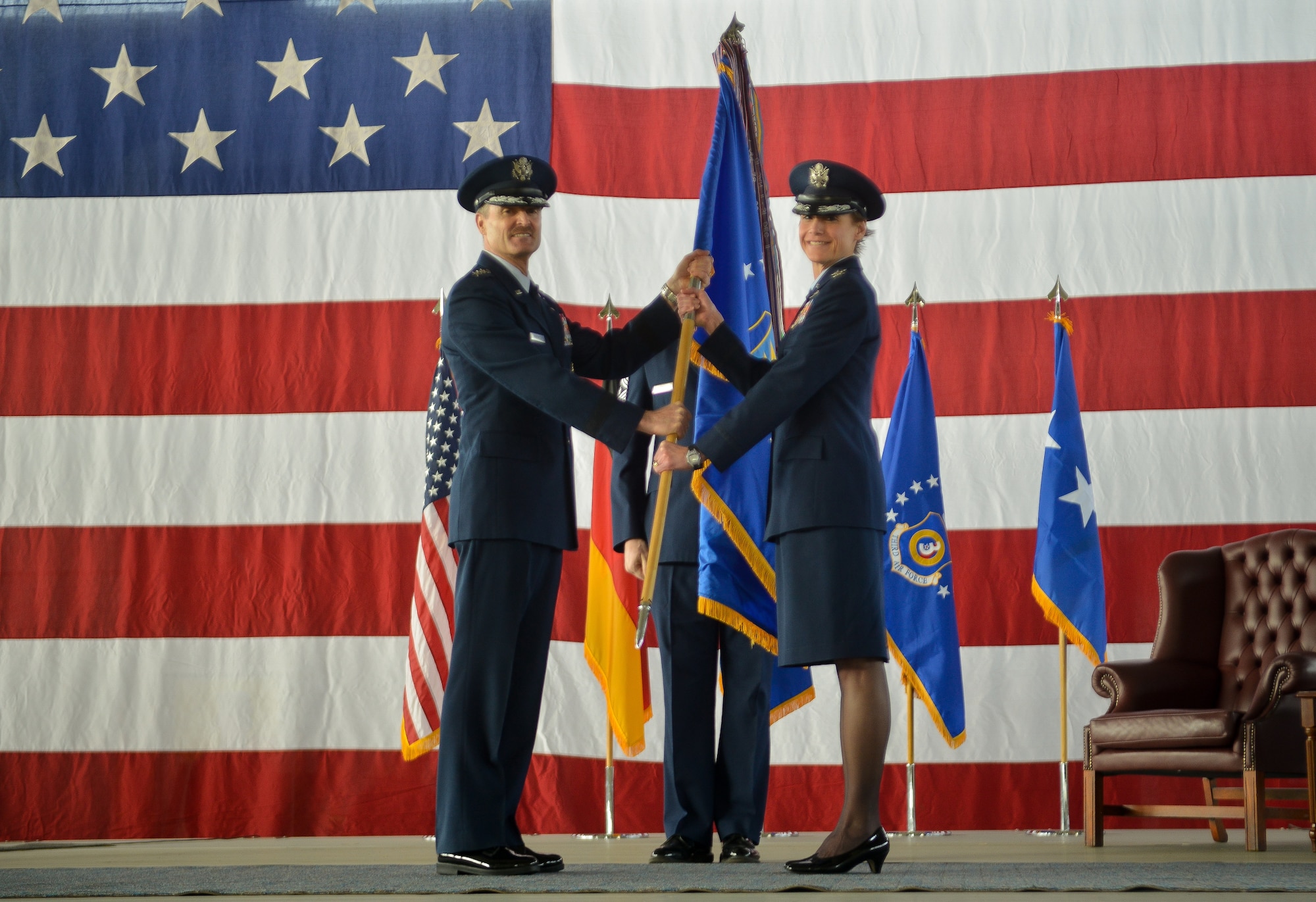 Lt. Gen. Darryl L. Roberson, 3rd Air Force and 17th Expeditionary Air Force commander, passes the 435th Air Ground Operations Wing and 435th Air Expeditionary Wing guidon to Col. Andra Kniep during an assumption of command ceremony March 16, 2015, at Ramstein Air Base, Germany. Kniep has served on 13 assignments in her Air Force career and most recently served as the 23rd Fighter Wing vice commander at Moody Air Force Base, Ga. (U.S. Air Force photo/Senior Airman Nicole Sikorski)