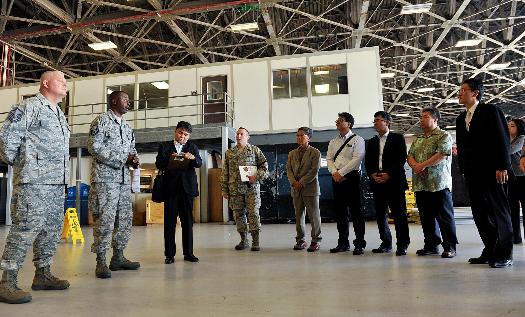 U.S. Air Force Master Sgt. Randolph McCollum, 18th Equipment Maintenance Squadron inspection section chief, explains the squadron’s mission and importance to honorary commanders during a tour on Kadena Air Base, Japan, March 17, 2015. The honorary commanders toured Kadena’s maintenance facilities to observe what the Airmen do on a day-to-day basis in their career field. (U.S. Air Force photo by Naoto Anazawa)