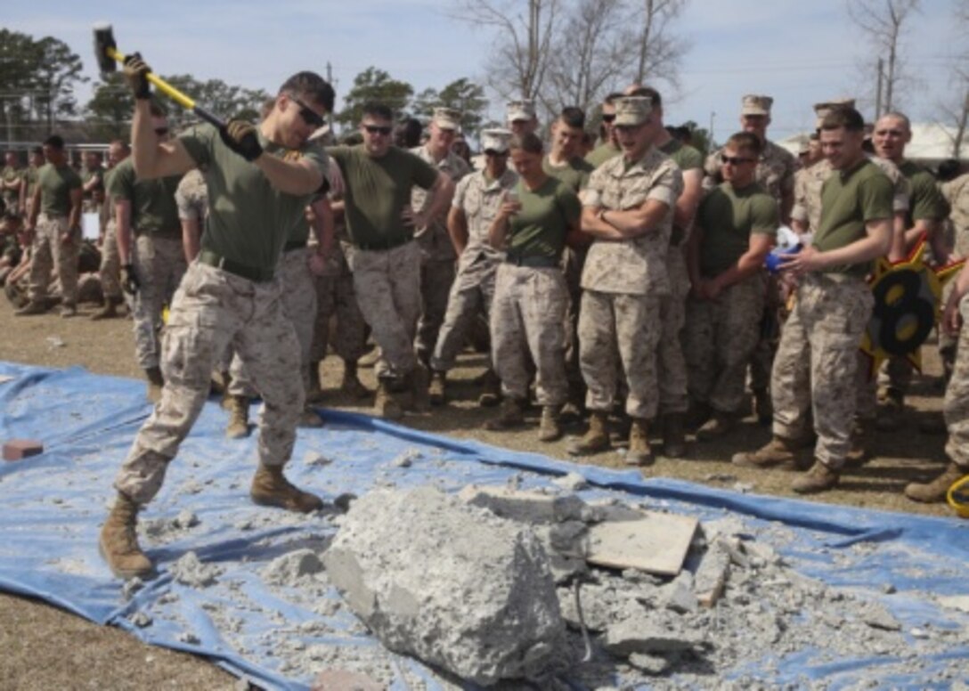 A Marine Corps engineer pounds apart a block of cement in order to be the first team to free the rebar from the center during the annual St. Patrick’s Day Engineer Field Meet, March 12, 2015, on Ellis Field at Courthouse Bay aboard Marine Corps Base Camp Lejeune, N.C. Engineers from across Camp Lejeune and New River Air Station came together to compete in 15 engineer-themed events in honor of the patron saint of engineers, St. Patrick. (U.S. Marine Corps photo by Cpl Michelle Reif/released)