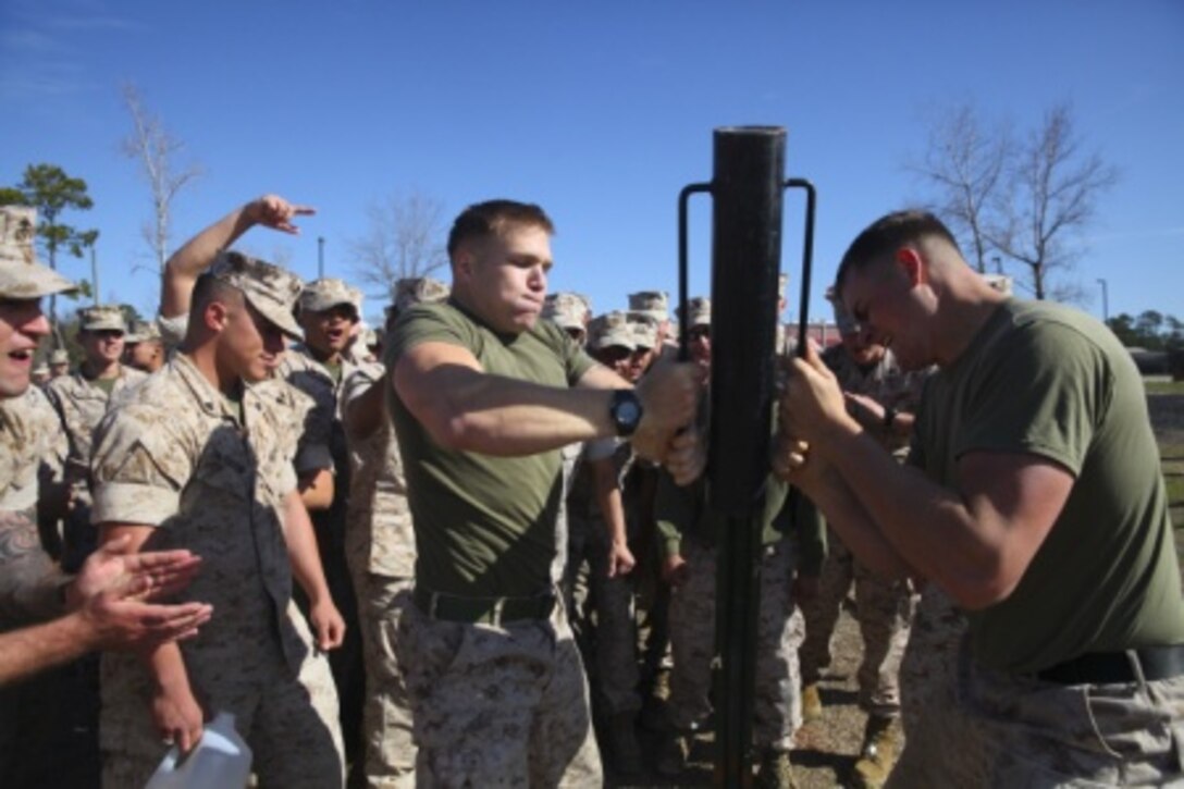 Two Marine Corps engineers drive a stake into the ground in a relay competition during the annual St. Patrick’s Day Engineer Field Meet, March 12, 2015, on Ellis Field at Courthouse Bay aboard Marine Corps Base Camp Lejeune, N.C. Engineers from across Camp Lejeune and New River Air Station came together to compete in 15 engineer-themed events in honor of the patron saint of engineers, St. Patrick. (U.S. Marine Corps photo by Cpl Michelle Reif/released)