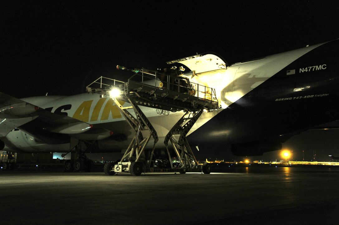 The first of six armed MD-530s leaves the transport aircraft and rolls onto an awaiting loader in Kubal, Afghanistan, March 17, 2015. The aircraft will provide additional close air attack capabilities for Afghan security forces. 