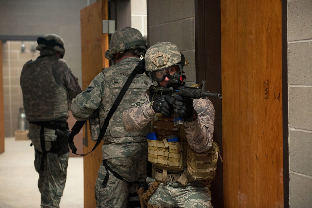 Air Force Staff Sgt. Jonathan Finer, foreground, provides security for the team during a shoot, move and communicate course at Orchard Combat Training Center near Gowen Field, Idaho, March 10, 2015. Finer is assigned to Idaho National Guard's 124th Security Forces Squadron. 
