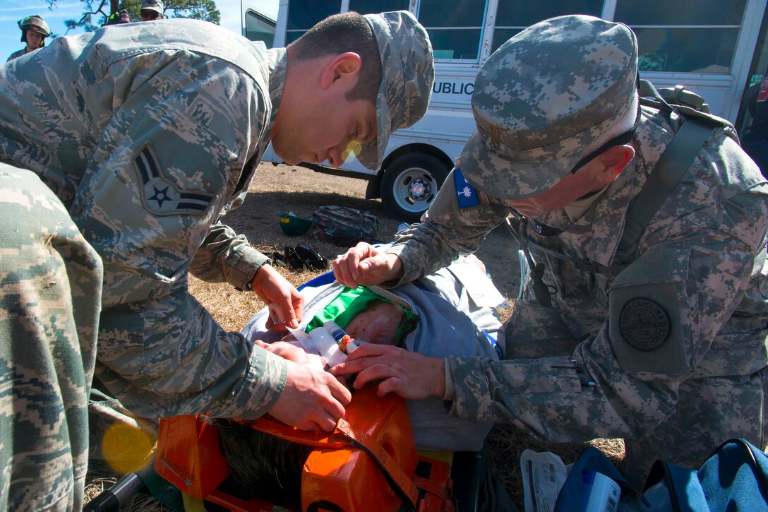 Air Force Airman 1st Class Ishmael Gutierrez, left, assists first responders in first aid to simulated victims during Vigilant Guard in Georgetown, S.C., March 8, 2015. .