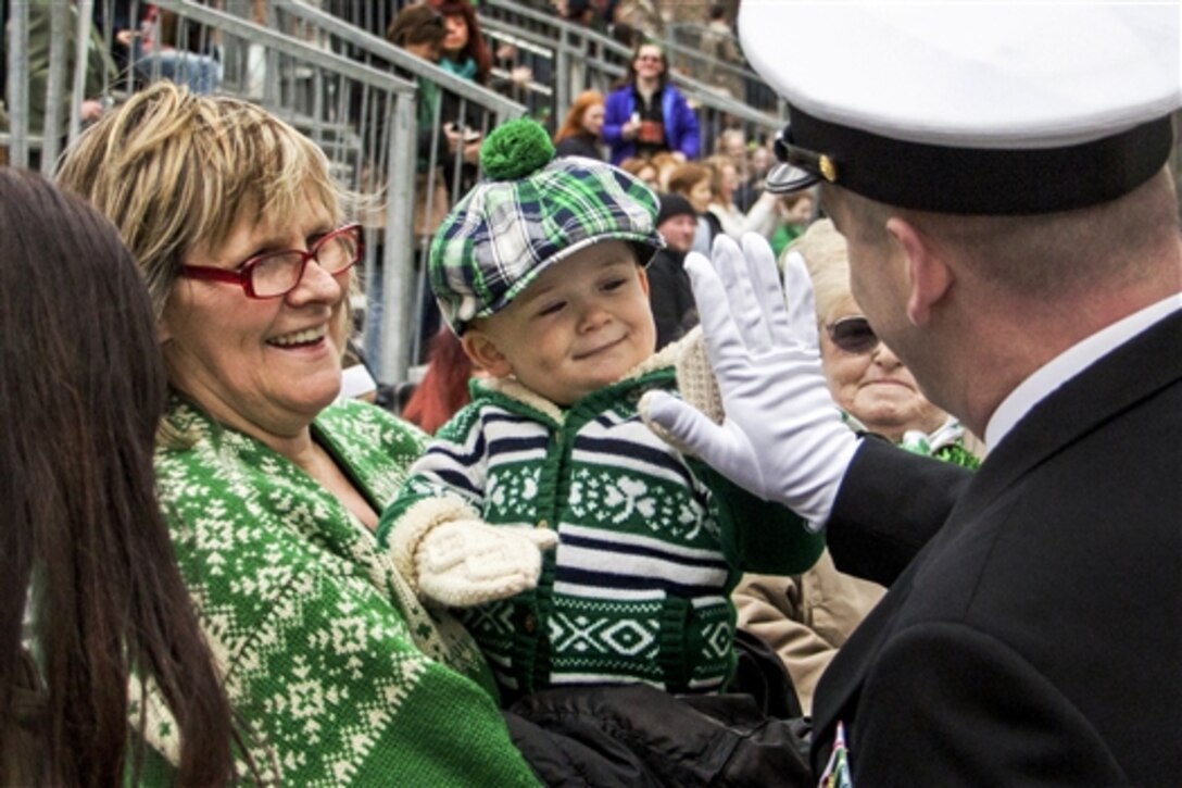 Navy Master Chief Petty Officer Christian Detje gets a high-five from a boy during the 254th St. Patrick's Day Parade in New York City, March 17, 2015. Detie is assigned to the U.S. Navy Ceremonial Guard.