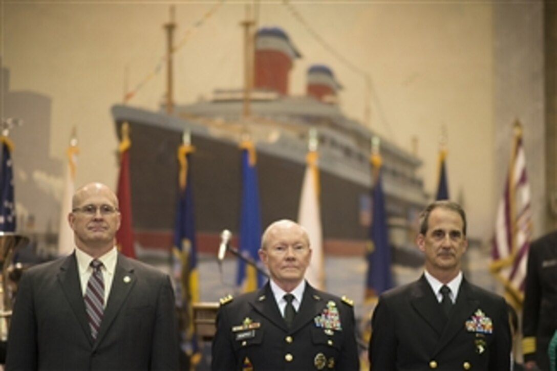 Army Gen. Martin E. Dempsey, center, chairman of the Joint Chiefs of Staff, and Navy Rear Adm. James A. Helis, right, U.S. Maritime Service Superintendent, attend the 27th Battle Standard Dinner at the U.S. Merchant Marine Academy in Kings Point, N.Y., March 16, 2015.