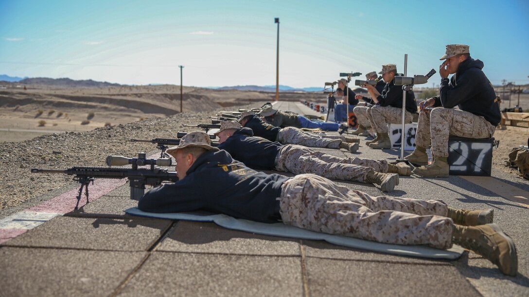 Marine Corps Air Ground Combat Center Gold shooters aim modified M16s at targets during the 7th Regiment Midrange Rifle Competition aboard the Combat Center, March 14, 2015. During the two day event, participants competed as individuals and as four man teams. 