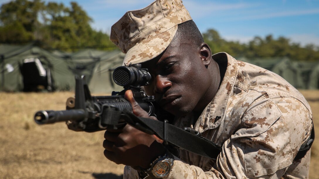 Lance Cpl. Dwayne Adams, a marksmanship instructor attached to II MEF Headquarters Group and Bronx, N.Y., native, provides security during the practical application portion of a class on combat formations during a MHG field exercise aboard Marine Corps Base Camp Lejeune, N.C., March 12-19, 2015. The purpose of the FEX was to allow the Marines the opportunity to test their skill sets and find areas of improvement. 
