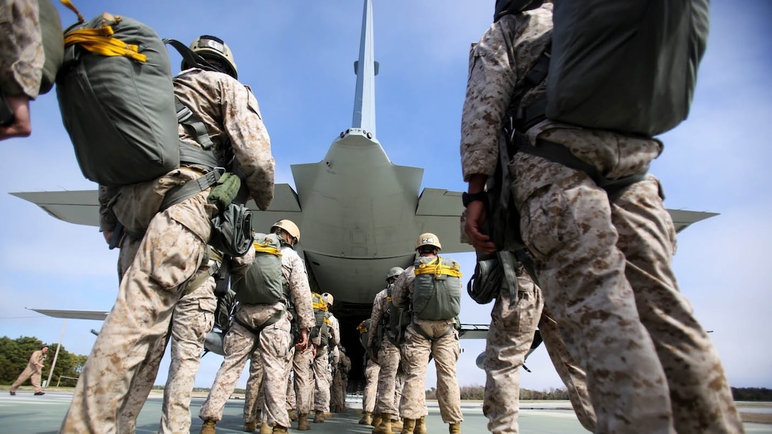 Marines in a jumpmaster course wait to board a C-130 aircraft at Bogue Airfield, Bogue, N.C., March 11, 2015. Army instructors from Fort Benning, Ga., came to Camp Lejeune to teach Marines what they need to know to be a jumpmaster, including how to perform personnel inspections, how to react to certain malfunctions and how to jump with several types of equipment.