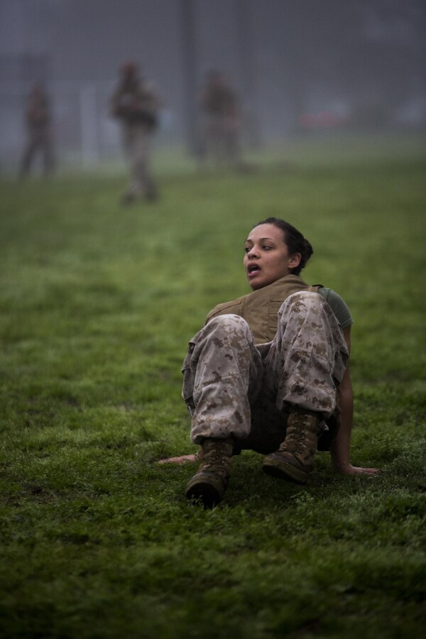 Corporal Olivia Goncalves, command deck administrative clerk, Marine Forces Reserve, crab walks to the finish line during a corporal’s course physical training session at Marine Corps Support Facility New Orleans, March 12, 2015. The Marines trained together to build their leadership abilities, increase their team-building skills and improve physical fitness. 