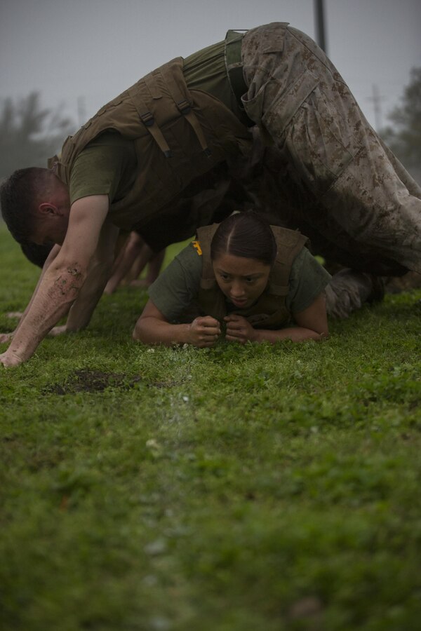 Corporal Tatiana I. Maldonado, aviation electronics technician with Marine Aircraft Group 49, 4th Marine Aircraft Wing, low crawls to the finish line during a corporal’s course physical training session at Marine Corps Support Facility New Orleans, March 12, 2015. The Marines trained together to build their leadership abilities, increase their team-building skills and improve physical fitness.