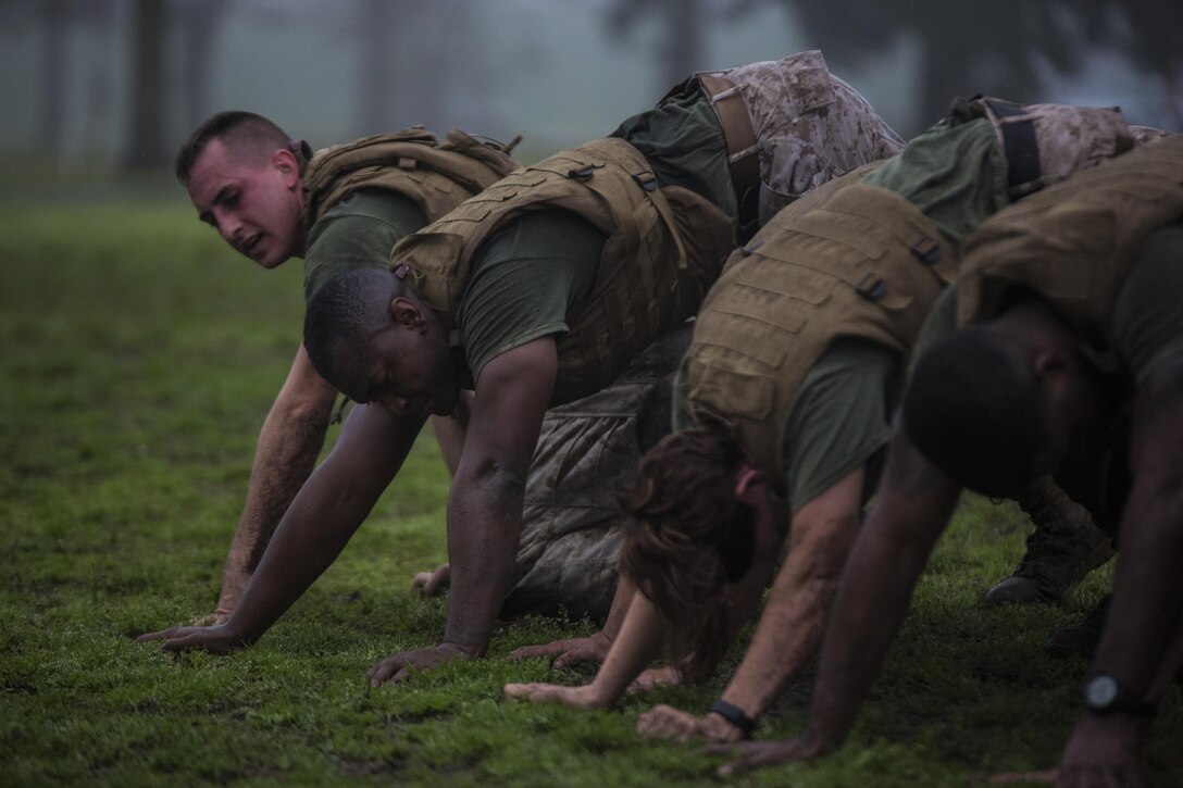 Marines with Marine Forces Reserve “build a house” during a corporal’s course physical training session at Marine Corps Support Facility New Orleans, March 12, 2015. The Marines trained together to build their leadership abilities, increase their team-building skills and improve physical fitness.