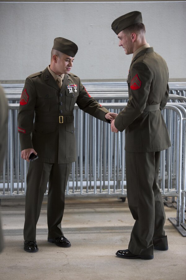 Sergeant Christopher Brandle, the faculty advisor for corporal’s course with Headquarters Battalion, Marine Forces Reserve, inspects Cpl. Jeremy T. Romano, power plant mechanic with Marine Aircraft Group 49, 4th Marine Aircraft Wing, during corporal’s course at Marine Corps Support Facility New Orleans, March 16, 2015. The uniform inspection was held to ensure that the corporals knew how to properly conduct an inspection. Marine noncommissioned officers are expected to lead and set the example for junior Marines. 