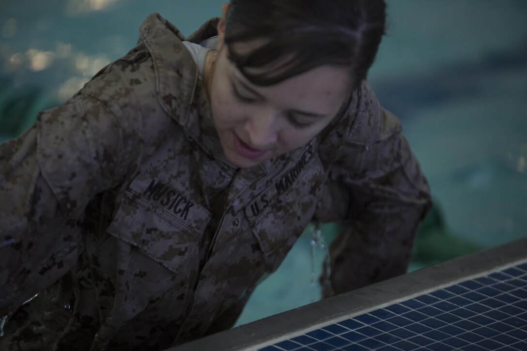 Corporal Brytani Musick, public affairs broadcast and media chief for Marine Forces Reserve, pulls herself out of the pool at Tulane University, New Orleans, for her annual swim qualification with corporal’s course, March 17, 2015. Marines completed the exercise together to ensure mission readiness and meet annual training requirements. 