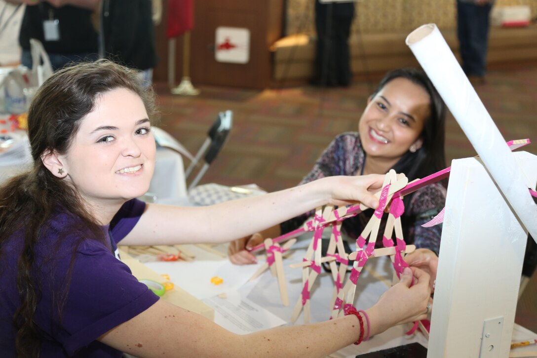 Caroline Hall (L) and Khaai Nguyen (R) from Fletcher High School, Team A, work on their car ramp project during Engineering Career Day 2015. 