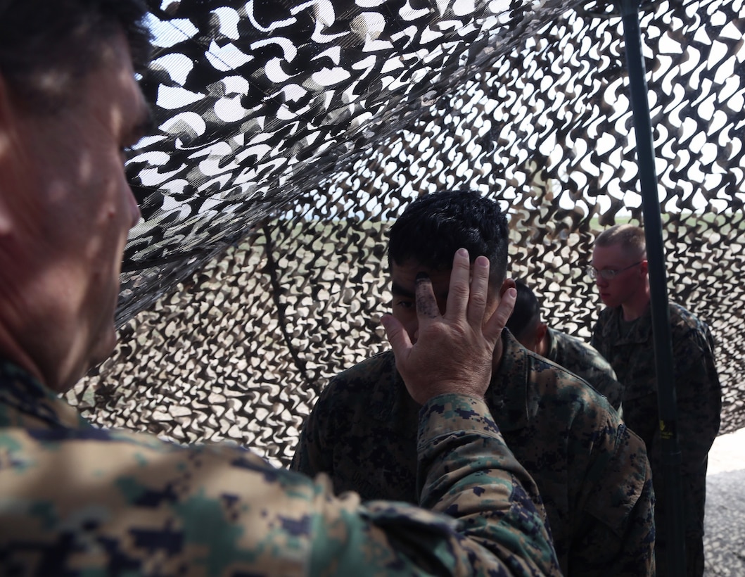 Navy Lt. Stephen Zachary, the chaplain for 1st Maintenance Battalion, Combat Logistics Regiment 15, 1st Marine Logistics Group, scribes an “ash cross” on a Marine with 1st Maintenance Bn. during the I Marine Expeditionary Force Exercise aboard Camp Pendleton, Calif., Feb. 22, 2015. Zachary provided Marines and Sailors with a service during the training operation for spiritual support. (Marine Corps photo by Sgt. Cody Haas/ Released)
